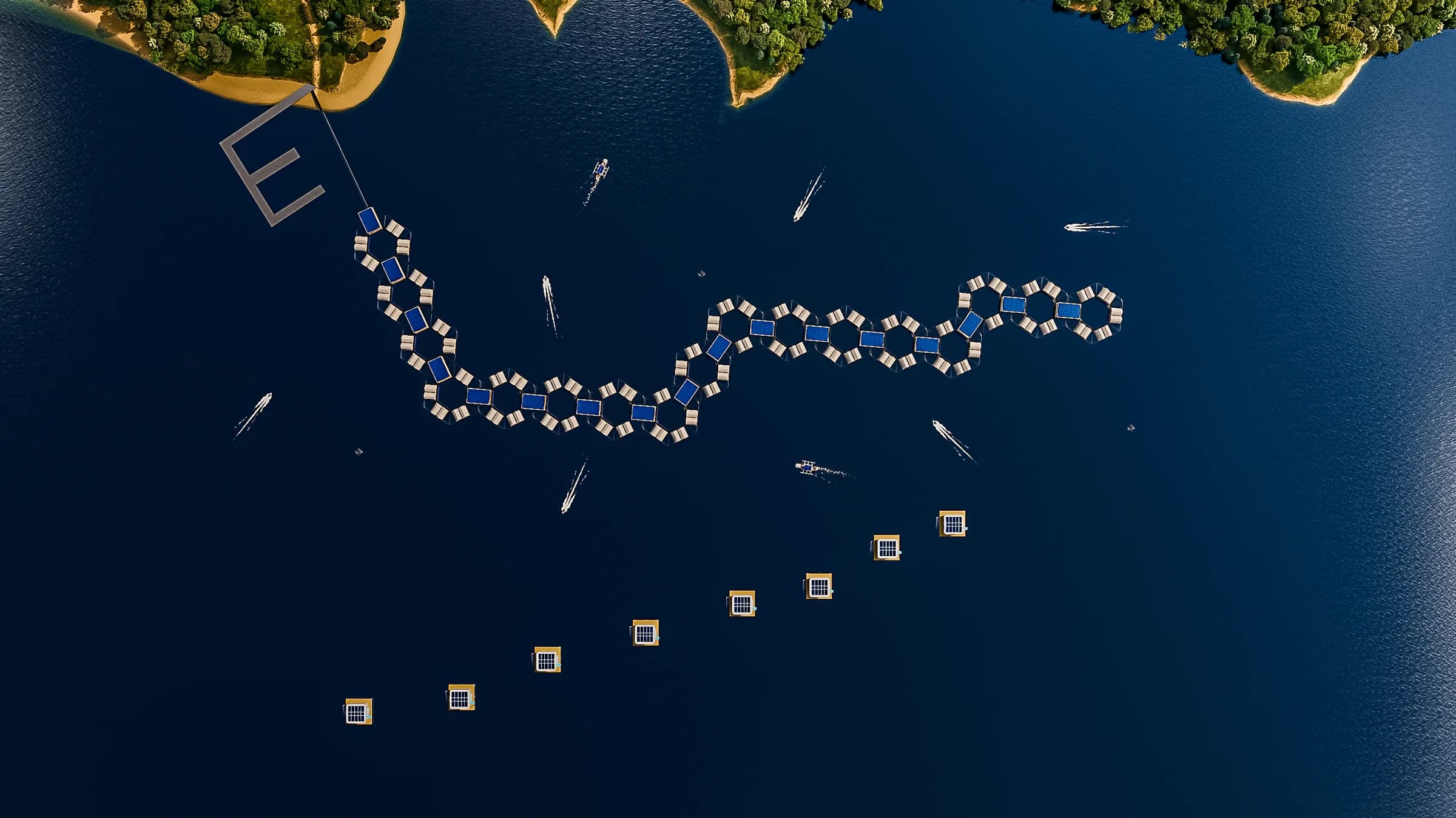Straight-down aerial of the proposed Roatan development: a long S-curve of hexagonal modules carrying white Glamphouses, with a separate diagonal row of square ArkPad units below, on deep blue water between two wooded headlands